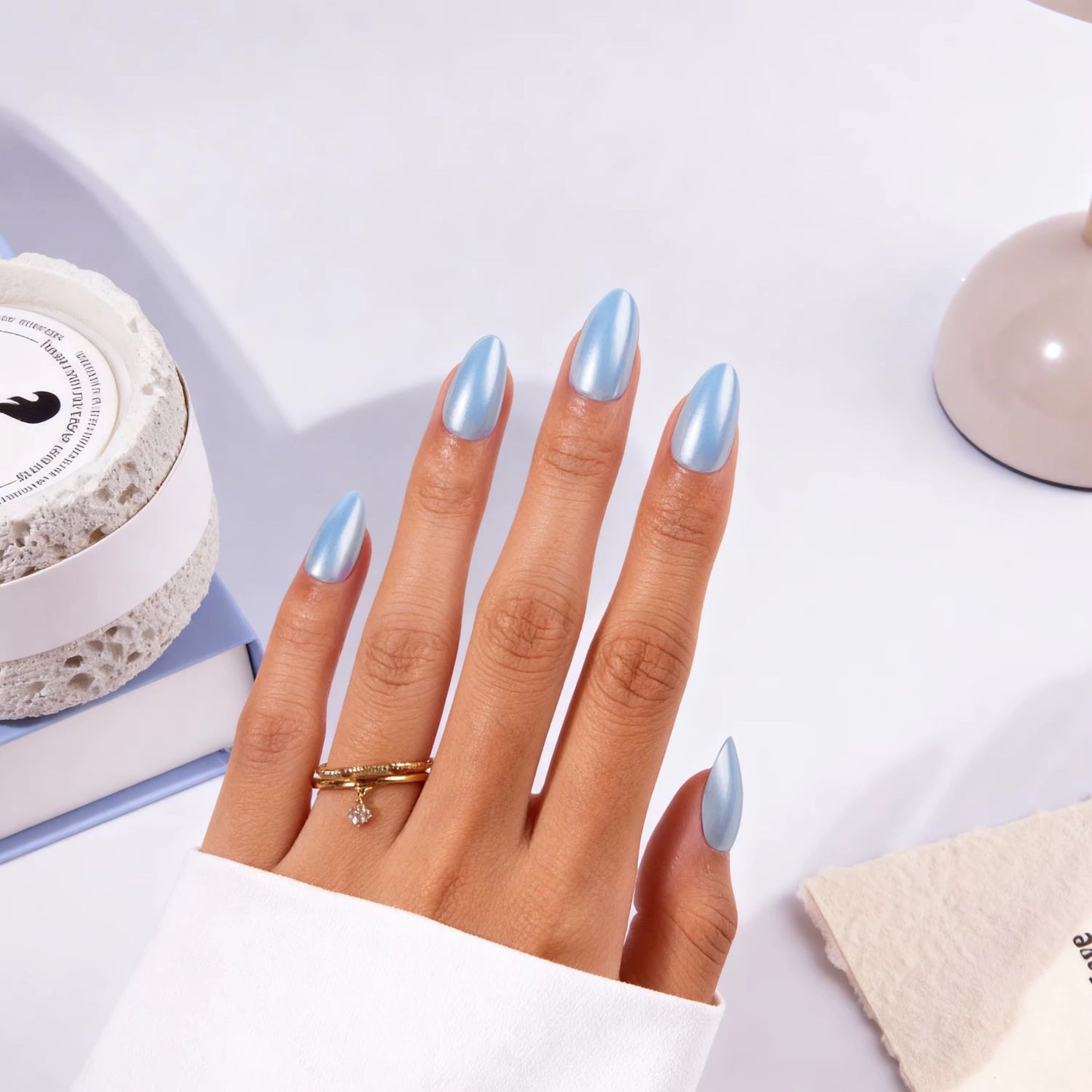 Sky Pearl Almond press-on nails worn on hand