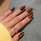 Amber Glow press-on nails - lifestyle hand shot