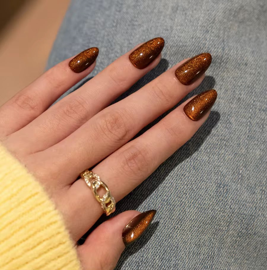 Amber Glow press-on nails - lifestyle hand shot