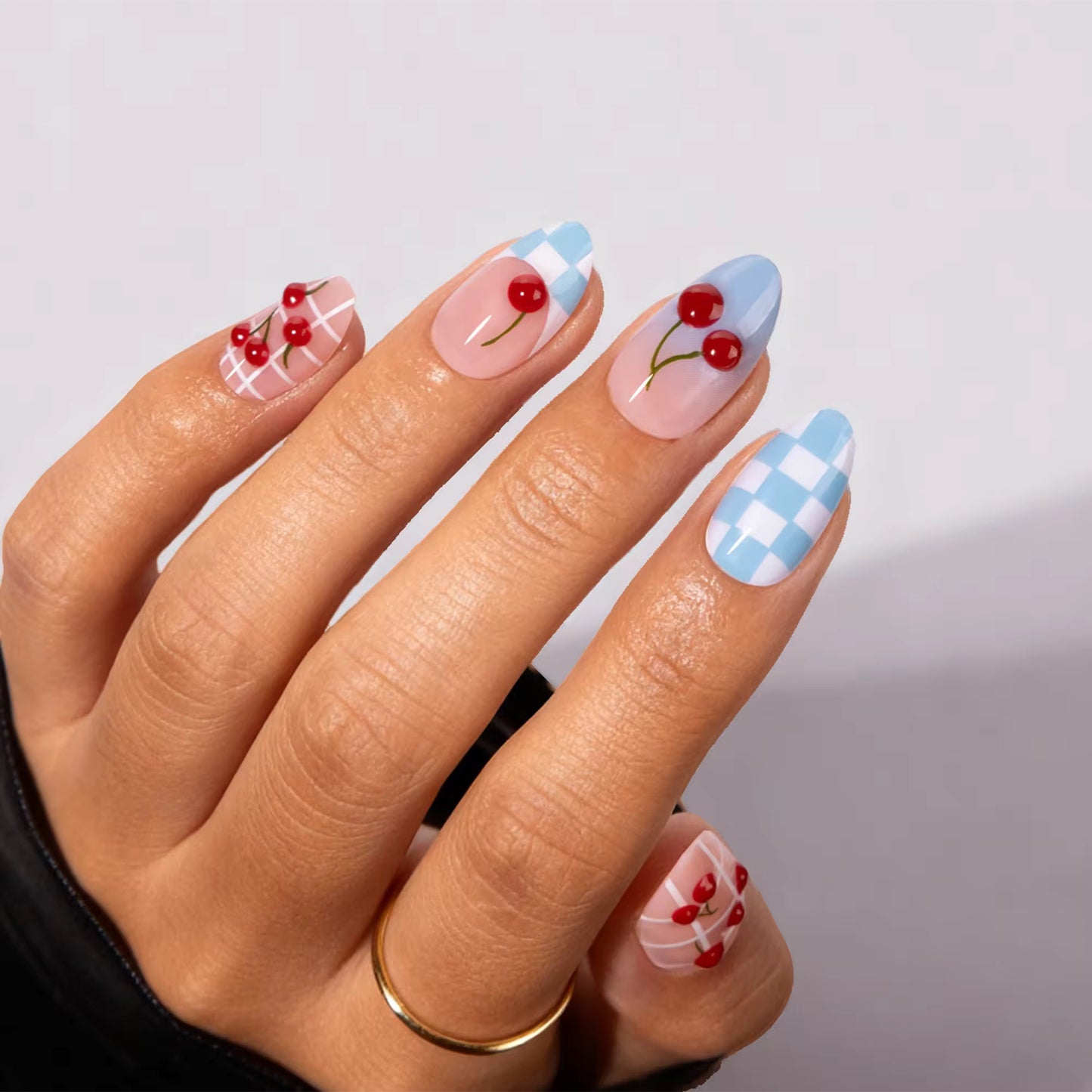 Cherry Checkerboard nails worn on hand
