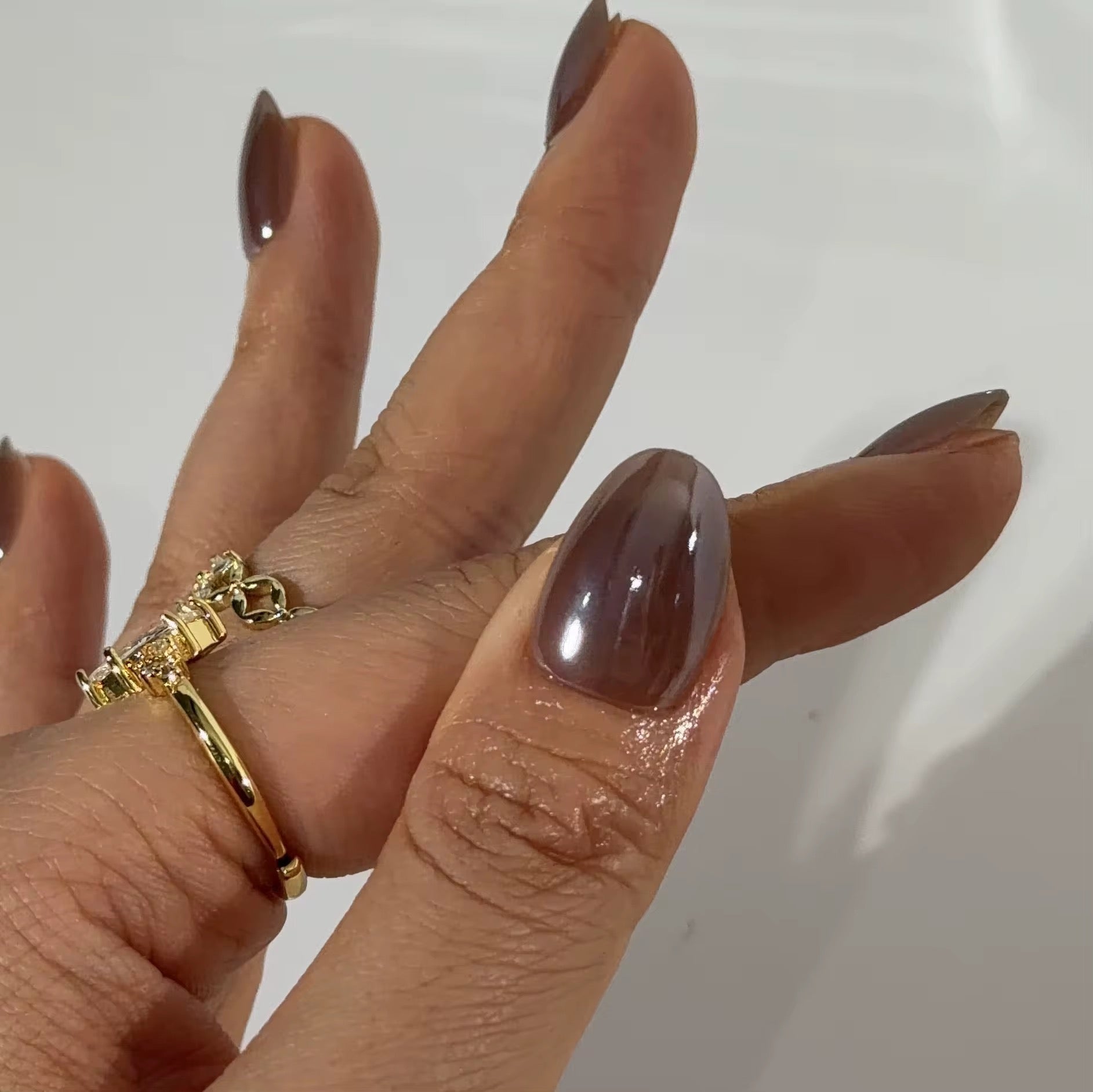 Cocoa Bean nails worn on hand