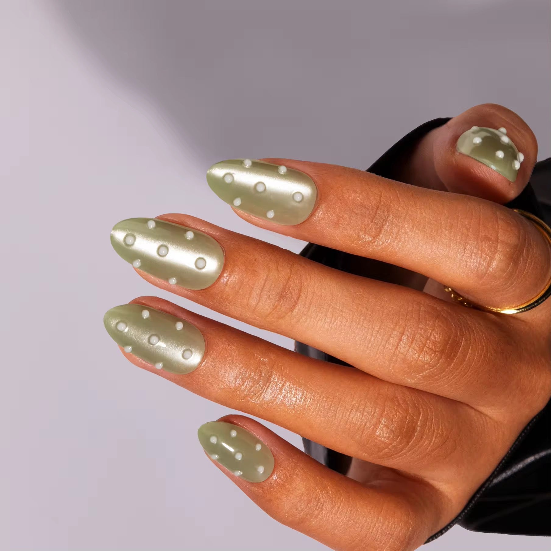 Golden Green Glow Pearls press-on nails - lifestyle hand shot