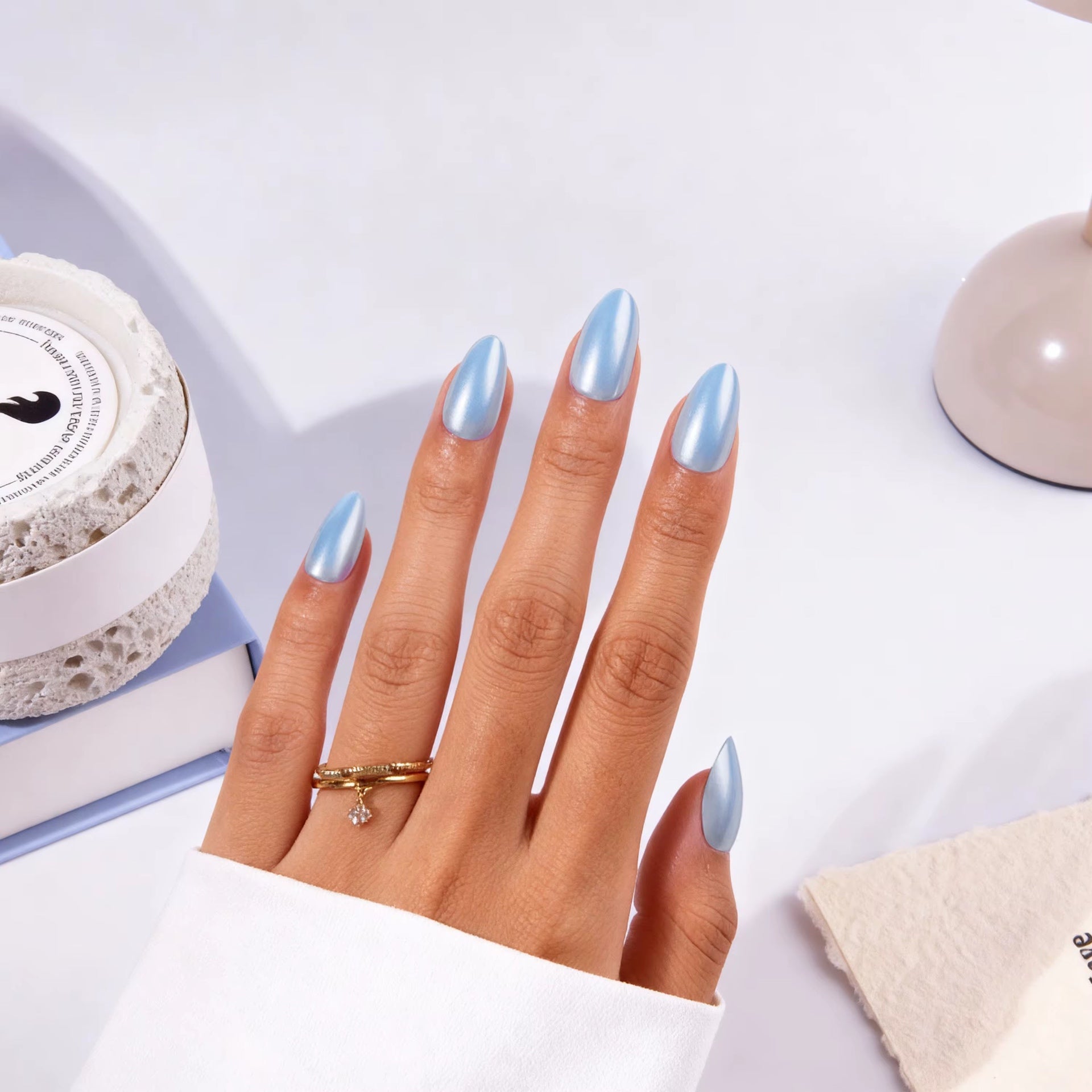Sky Pearl Almond press-on nails worn on hand