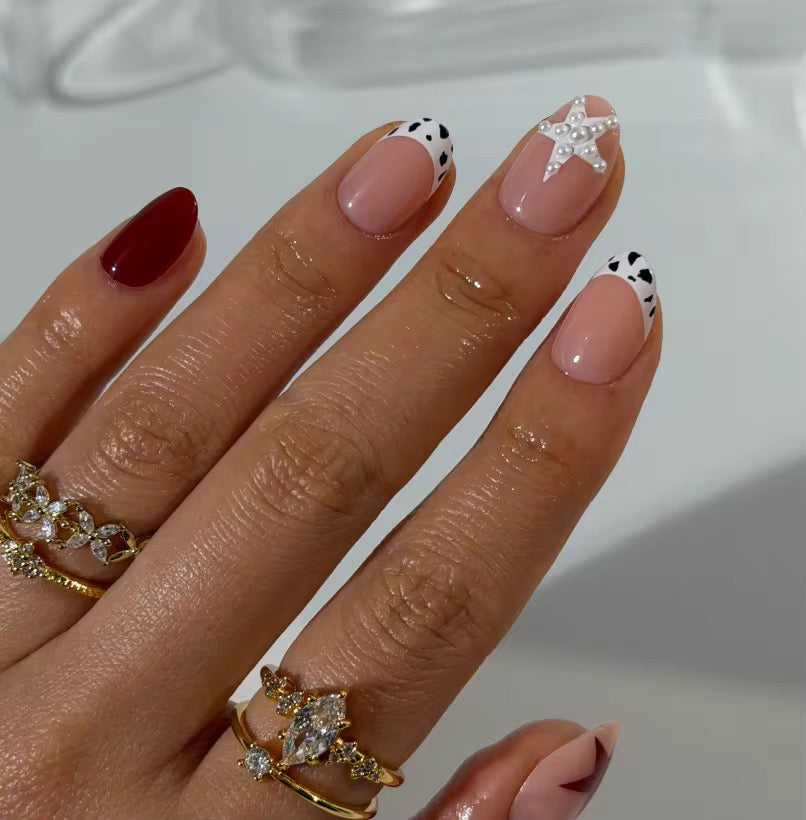 Starry Cow press-on nails styled on hand