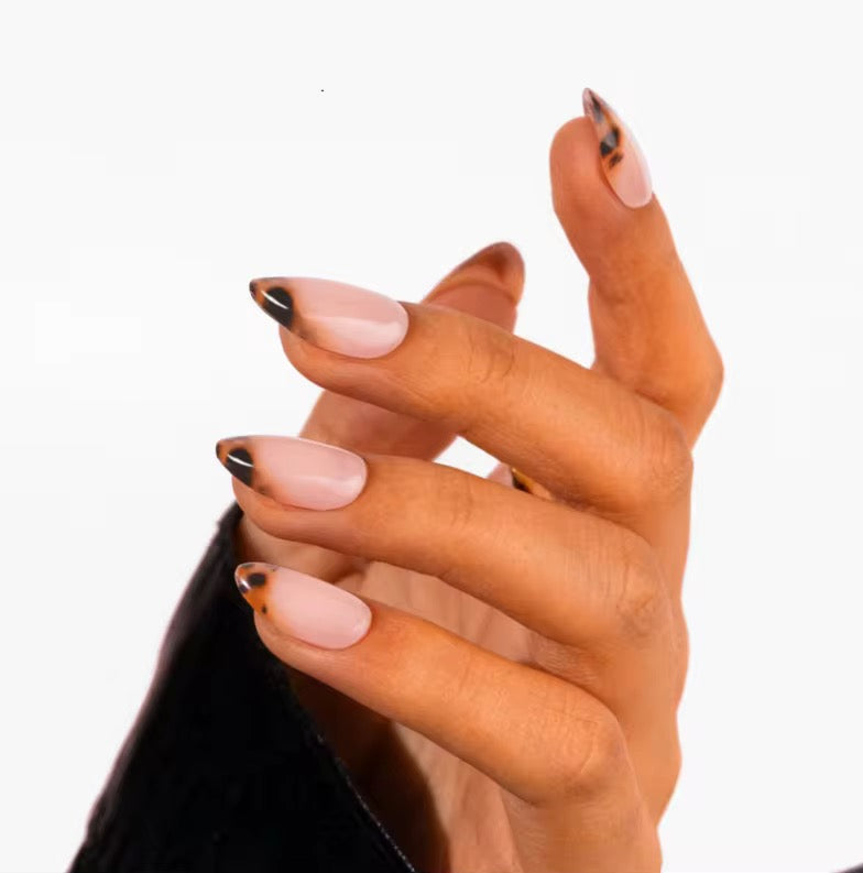 Tortoiseshell French Almond nails worn on hand